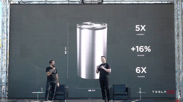 Elon Musk, right, and Drew Baglino, a Tesla executive, said battery advances could over time cut costs more than 50 percent.