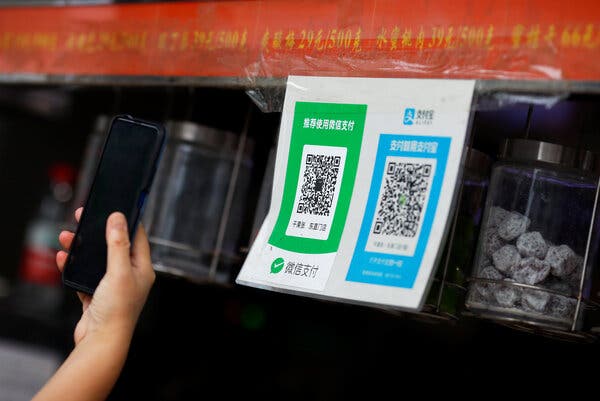 QR codes for WeChat and Alipay in a shop in Beijing. Starting Sunday, users in the United States won’t be able to send payments to family members or businesses that use WeChat as a payment method.