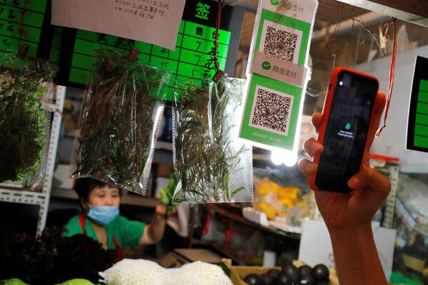 Scanning a QR code using the digital payment services WeChat Pay at a market in Beijing. The Trump administration will bar such payments in the United States at midnight on Sunday.
